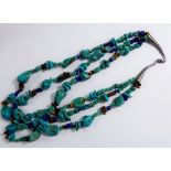A turquoise lapis lazuli and tigers eye bead necklace with tapered silver clasps