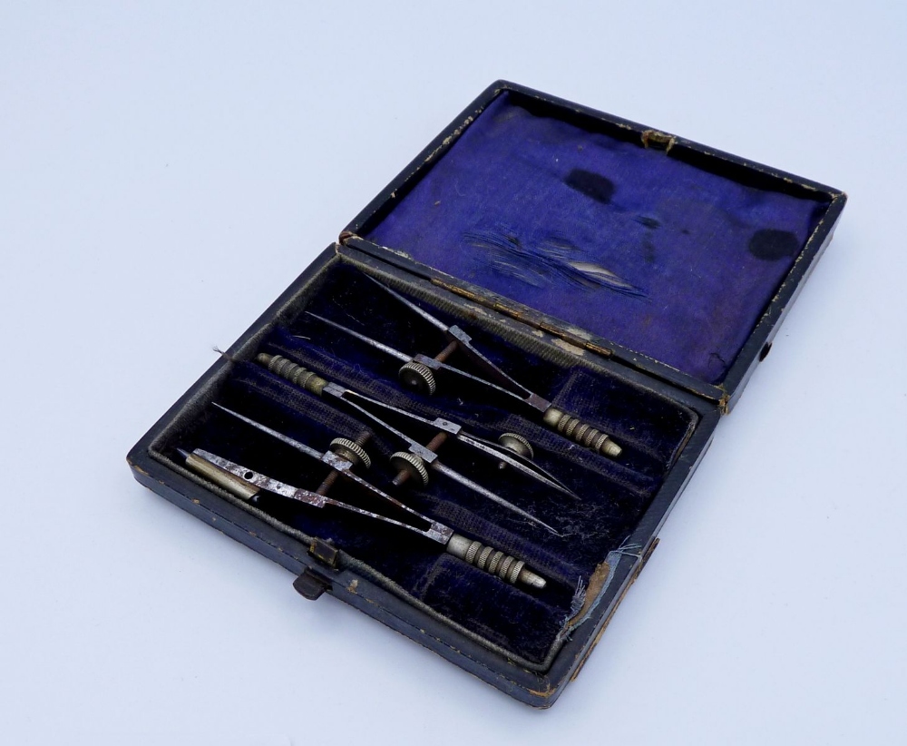 An antique compass set in original silk and velvet lined case