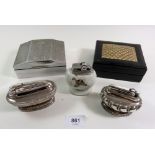 A Ronson silver plated table lighter and two others, a white metal Art Deco cigarette box and