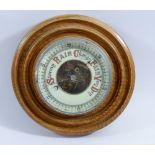 A light oak framed circular barometer