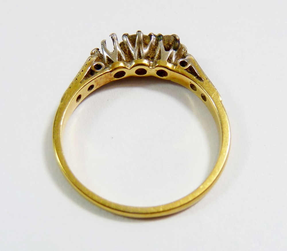 An Edwardian 18 carat gold three stone diamond ring (one stone deficient) on diamond chip shoulders, - Image 3 of 3