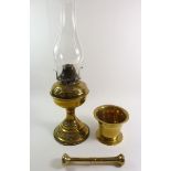 A brass pestle and mortar 9.5cm tall and a brass oil lamp