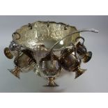A silver plated large punch bowl 27cm diameter, with eight punch cups and ladle