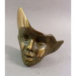 A limited edition bronze mask, signed Taton 9cm tall