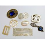 Five mother of pearl buckles and two brooches etc