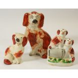 A Victorian Staffordshire group two dogs with a barrel, 11cm and two other small Victorian dogs