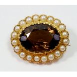 A 9 carat gold oval brooch set citrine in pearl surround, 2.8 x 2.2cm, 6.6g