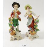 A pair of porcelain figures with gold anchor marks to back, 16cm tall