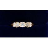 An 18 carat gold ring set brilliant cut diamond flanked by baguette cut diamonds and four smaller