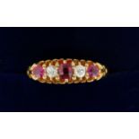 An 18 carat gold ring set three rubies and two diamonds, size O to P