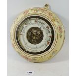 An Edwardian floral pottery framed aneroid barometer 28cm diameter