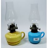 A Victorian yellow opaque glass finger lamp and a blue one