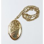 A 9ct gold oval engraved locket and a 9ct gold chain, total weight 19.2gm