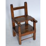 An 18th century continental elm seated child's chair with later table tray