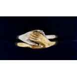 A 14 carat yellow and white gold two part friendship ring with two interlocking hands, 5g