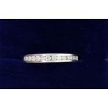 An 18 carat white gold ring channel set diamonds, 25g, size K