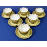 An Edwardian yellow and gilt set of six porcelain cups & saucers with silver pierced and