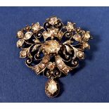 An antique gold and silver backed diamond pendant/brooch, with old cut diamonds in openwork scroll