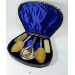 A silver five piece dressing table set, boxed, Birmingham 1938