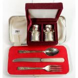 A pair of silver plated milk churn form salt and pepper pots and a silver plated christening cutlery