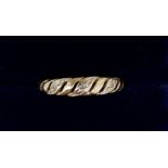 An early 20th century 9 carat gold ring set three chip diamonds size K-L