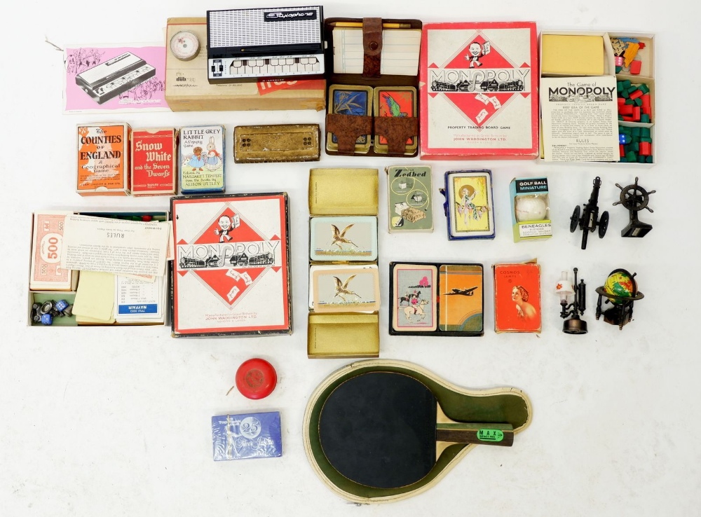 A box of collectables including various playing cards, a Stylophone etc