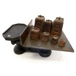 A set of cast iron and copper military GPO postal scales with broad arrow mark and set of seven