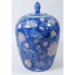 A Chinese vintage jar and cover painted pink flowers on a blue ground, 26cm