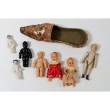 An oriental miniature slipper, a bisque dolls house doll, 5.5cm and various other miniature dolls