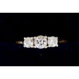 An 18 carat gold three stone diamond ring, 2g, size I - J