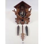 A Black Forest cuckoo clock with weights and pendulum
