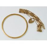 A 9 carat gold bangle, 8.2cm diameter, 6.5g and a 9 carat gold gate link bracelet, 15.6g