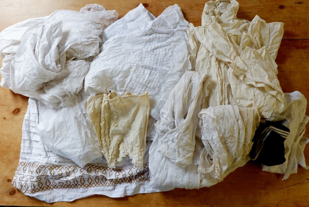 A quantity of Victorian white petticoats, aprons etc.