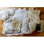 A quantity of Victorian white petticoats, aprons etc.