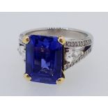 A fine 18ct white gold ring set large emerald cut sapphire flanked by two pear cut diamonds on