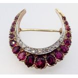 A 9 carat yellow and white gold crescent form brooch set rubies and diamonds, 2.8cm