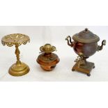 A copper samovar, a brass trivet and a copper oil lamp