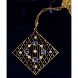 An Edwardian 15ct gold square openwork pendant set sapphires and seed pearls, in original box with