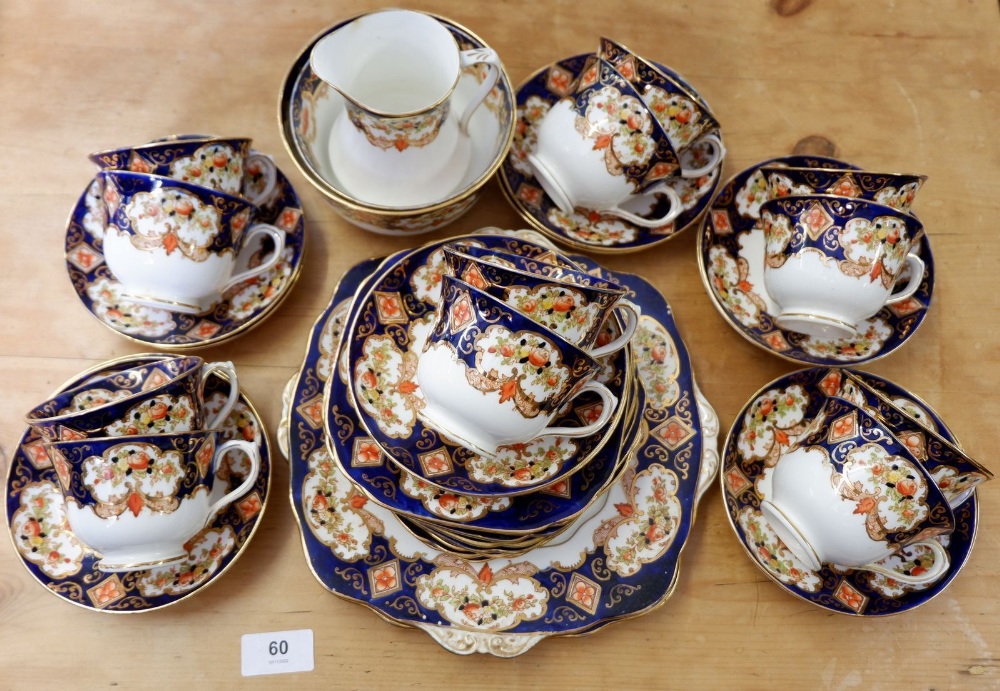 An Edwardian Royal Albert tea service comprising twelve cups and saucers, two cake plates, sugar and
