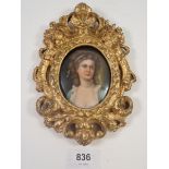 A miniature portrait painted on oval porcelain plaque of a woman, marked to verso Potoroka, Firenze,