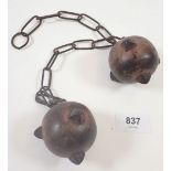 A pair of antique tupping balls to prevent ram's mating