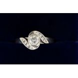 An 18 carat white gold ring set central diamond (1/4 carat approx.) in diamond crossover setting,