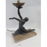 An Art Deco bronze finish plaster light fitting on 'marble' base with dancer holding lamp aloft