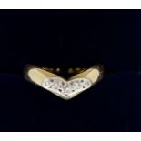 A 9 carat gold wishbone form ring set five diamonds, size M