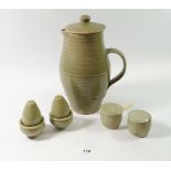 A Leach Pottery green glazed covered jug and a six piece cruet set