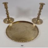 A Chinese brass engraved oval tray and a pair of brass candlesticks