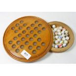 A Victorian solitaire board with marbles stored to base and written instructions