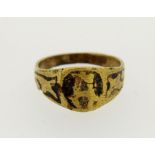 An antique brass ring with 'A' monogram