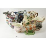 A Victorian cow creamer and five various Victorian jugs, some damage