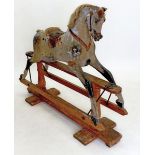An antique Ayres style dapple grey rocking horse in need of restoration, 120 x 140cm